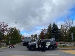 Police are seen near the site of a shooting in the Laurentian community of Estérel on Friday, Oct. 7, 2022.