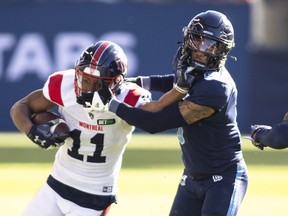 Montreal Alouettes receiver Kaion Julien-Grant (11) fights off Toronto Argonauts defensive-back Royce Metchie (9) during first half CFL football action in Toronto on Saturday, Oct. 29, 2022.