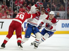 Detroit Red Wings defenceman Gustav Lindstrom (28) checks Canadiens' Brendan Gallagher (11) on Friday, Oct. 14, 2022, in Detroit.