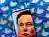 An image of Elon Musk is seen on a smartphone placed on printed Twitter logos in this picture illustration.