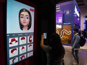 A young woman makes a virtual image of herself at a TikTok stand during the international influencer convention Vidcon in Mexico City in September 2022.