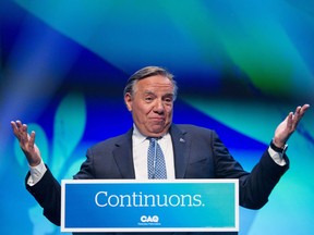 François Legault celebrates his re-election and the landslide win by the Coalition Avenir Québec in Monday's Quebec election at his party's post-election gathering in Quebec City.