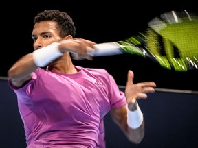 Félix Auger-Aliassime returns ball to Carlos Alcaraz during their men's singles tennis semi-final match at the Swiss Indoors ATP 500 tournament in Basel on Oct. 29, 2022.