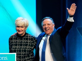 Premier Francois Legault waves to supporters alongside his wife Isabelle Brais to make his victory speech at the Coalition Avenir Quebec election night headquarters, in Quebec City, Monday, Oct. 3, 2022.