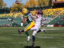 Alouettes' Mike Jones (8) and Edmonton Elks Vincent Forbes-Mombleau (82) via for the ball in Edmonton on Saturday, Oct. 1, 2022.