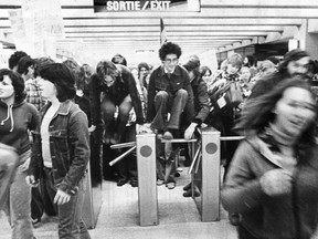 Students protesting transit fare increases jump over a métro turnstile in this photo published on Page 1 of the Montreal Gazette on Oct. 24, 1975.