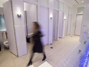 A woman walks in an all-gender washroom at Yorkdale Mall in Toronto on Tuesday, Dec. 11, 2018.