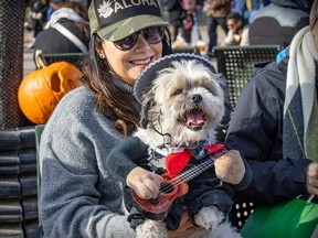 Diana Marleau dressed her dog Chato as a Mariachi musician during Pawsome Club MTL's Halloween costume party at Sit Wilfrid Laurier Park in Montreal on Saturday, Oct. 29, 2022.