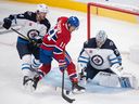 Montreal Canadiens' Brendan Gallagher moves in on Winnipeg Jets goaltender David Rittich as Jets' Dylan Samberg defends during second period in Montreal on Sept. 29, 2022.