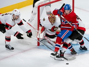 Montreal Canadiens? Rafael Harvey-Pinard gets tripped up by Ottawa Senators defenders during third period NHL action in Montreal, Tuesday, Oct. 4, 2022.
