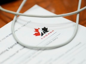 A Hockey Canada document is review by a member of Parliament during a House of Commons Committee on Canadian Heritage looking into safe sport in Canada on Parliament Hill in Ottawa on Oct. 4, 2022.