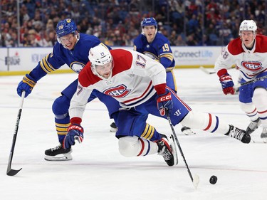 Buffalo Sabres defenceman Lawrence Pilut (20) knocks Montreal Canadiens right wing Josh Anderson (17) off the puck during the third period at KeyBank Center in Buffalo, N.Y., on Oct. 27, 2022.