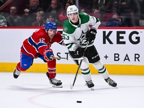 Dallas Stars centre Wyatt Johnston (53) controls the puck against Canadiens' Rem Pitlick (32) during the third period at the Bell Centre in Montreal on Saturday, Oct. 22, 2022.