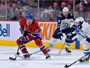 Montreal Canadiens defenceman Arber Xhekaj moves the puck against Winnipeg Jets forward Brad Lambert during the first period at the Bell Centre in Montreal on Sept. 29, 2022. 