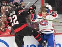Canadiens' Michael Pezzetta (55) loses his helmet in a check to Senators defenceman Nikita Zaitsve (22) at the Canadian Tire Centre in Ottawa on Saturday, Oct. 1, 2022.