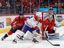 Canadiens' Nick Suzuki (14) scores a goal on Capitals goaltender Darcy Kuemper (35) as Capitals defenceman Nick Jensen (3) defends in the second period at Capital One Arena on Saturday, Oct. 15, 2022, in Washington, D.C.