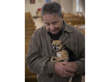 Giussepe Cappuccilli holds Palou at a Blessing of the Animals event at Sainte-Catherine-de-Sienne church in Notre-Dame-de-Grâce on Sunday, Oct. 2, 2022. Palou is the dog of Sainte-Catherine-de-Sienne parish priest Jean-Pierre Couturier.