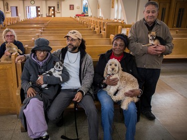 People brought their animal friends to Sainte-Catherine-de-Sienne Church in Notre-Dame-de-Grâce on Sunday, Oct. 2, 2022, for a Blessing of the Animals event. Humans from the left are: Anne Mackay, Michele Henegan, Ben Comeau, Ranee Lee and Giussepe Cappuccilli. Animals from the left, are Oscar, Beanie, Cali and Palou.