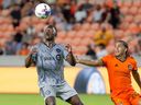 CF Montréal midfielder Victor Wanyama, left, brings down the ball in front of Houston Dynamo midfielder Adalberto Carrasquilla during the second half on Aug. 13, 2022, in Houston.