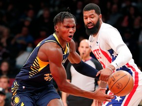 Indiana Pacers guard Bennedict Mathurin (00), left, is fouled by Brooklyn Nets forward Markieff Morris, right, during the first half of an NBA basketball game, Saturday, Oct. 29, 2022, in New York.