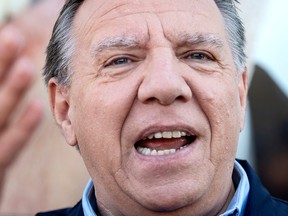 Coalition Avenir Québec Leader François Legault speaks with supporters during an election campaign stop at a market in Magog on Sunday, Oct. 2, 2022. Quebecers will go to the polls on Monday.