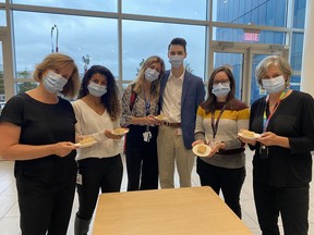 McGill University Health Centre staff members Julie Woodfine, left, Christiane Azzi, Megan Kouri, Brandon Hall, Maryse Fournier and Dr. Marie-Josée Brouillette with plates of bannock in September 2022.