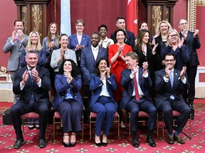 Quebec Liberal Leader Dominique Anglade, centre, applauds with members of her newly sworn in caucus during a ceremony at the legislature in Quebec City, Tuesday, Oct. 18, 2022. Vaudreuil MNA Marie-Claude NIchols is far right in the middle row.