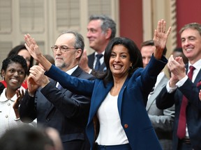 Quebec Liberal Leader Dominique Anglade waves to the guests as she enters with her elected caucus to be sworn in during a ceremony at the legislature in Quebec City on Oct. 18, 2022