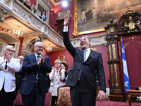 Quebec Premier François Legault waves to guests as he and his Coalition Avenir Québec caucus is sworn in, Tuesday, Oct. 18, 2022 during a ceremony at the legislature in Quebec City.