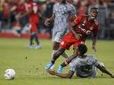 Toronto FC defender Richie Laryea (19) collides with CF Montreal forward Mason Toye (13) during second half of MLS soccer in Toronto on Sunday, Sept. 4, 2022.