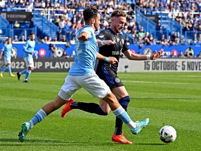 CF Montréal midfielder Djordje Mihailovic, right and New York City forward Kevin O'Toole go for the ball during the first half of the MLS conference semifinals at Saputo Stadium on Sunday, Oct. 23, 2033. Mihailovic is off to the Netherlands after CFM's 3-1 loss to NYC.