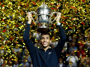 Montreal's Félix Auger-Aliassime celebrates with trophy after winning his final match against Denmark's Holger Rune at the Swiss Indoors Basel tournament on Oct. 30, 2022.