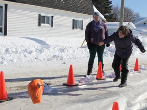 Lilly Rochefort tries her hand at turkey bowling in northern Ontario in 2019. Her mother, Diane, is cheering her on.