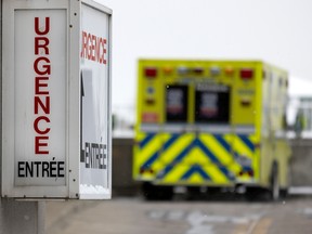 ambulance pulls into hospital with er sign in foreground