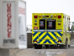 An ambulance leaves the emergency entrance of a hospital.