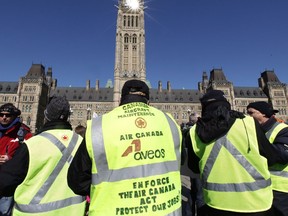 Locked-out Aveos maintenance workers, who maintained Air Canada aircraft, protest on Parliament Hill in Ottawa, Tuesday March 27, 201.&ampnbsp;Air Canada violated federal law by not keeping its aircraft maintenance centres in Montreal, Winnipeg and Mississauga operational during the collapse of Aveos, a decade ago, the Quebec Superior Court ruled Thursday in a ruling for thousands of former workers.
