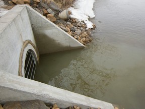 Cloudy water is seen being discharged into Rivière des Prairies from a discharge pipe next to a pumping station in Laval in 2016.