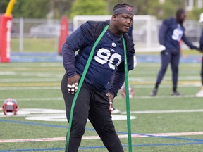 Defensive lineman Almondo Sewell uses a rubber band while stretching during practice at the Montreal Alouettes training camp on May 26, 2022 in Trois-Rivieres.