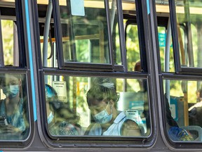 Transit riders wear masks on a Montreal bus last July. "Claims that there is no data supporting mask use are just untrue," Dr. Christopher Labos writes.