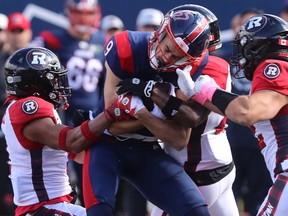 Alouettes's Jake Wieneke (9) is tackled by Ottawa Redblacks's Patrick Levels, left, and Adam Auclair, right,  in Montreal on Monday, Oct. 10, 2022. "We have faith in each other," Wieneke says as the Alouettes prepare for Sunday's East Division final against the Toronto Argonauts. "We know we're going to go out there and get the job done."