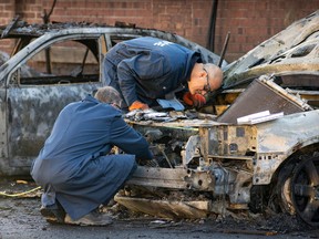 Montreal police vehicle identification experts collect evidence after cars were set on fire in Lachine Nov. 4, 2022.