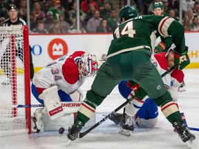 Canadiens' Jake Allen makes a save as Minnesota Wild centre Joel Eriksson Ek looks for a rebound in the second period at Xcel Energy Center in Saint Paul, Minn., on Nov. 1, 2022.