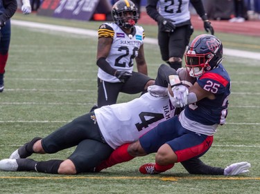 Hamilton Tiger-Cats defensive back Richard Leonard (4) can't prevent Alouettes running back Walter Fletcher (25) from scoring a touchdown during first half CFL Eastern Conference semifinal action at Percival Molson Stadium in Montreal on Sunday, Nov. 6, 2022.