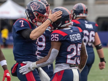 Alouettes quarterback Trevor Harris (7) congratulates teammate  running back Walter Fletcher (25) after scoring a touchdown during first half CFL Eastern Conference semifinal action at Percival Molson Stadium in Montreal on Sunday, Nov. 6, 2022.
