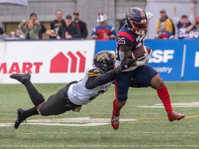 Hamilton Tiger-Cats linebacker Simoni Lawrence, 21, backs Walter Fletcher, 25, during the CFL Eastern Conference first half semifinals at Percival Molson Stadium in Montreal on Sunday, November 6, 2022. I will try to defeat the running Alouette.
