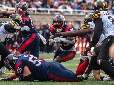 Montreal Alouettes running back Walter Fletcher (25) drives through the opening in the front line against the Hamilton Tiger-Cats during second half CFL Eastern Conference semifinal action at Molson Stadium in Montreal on Sunday, Nov. 6, 2022.