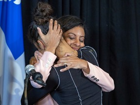 Quebec Liberal Party Leader Dominique Anglade hugs daughter Clara after announcing her resignation as party leader and as MNA Nov. 7, 2022.