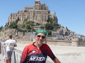 McGill University professor Larry Lessard in front of the abbey at Mont-Saint-Michel, France, as he nears the halfway point of his cycling trip.