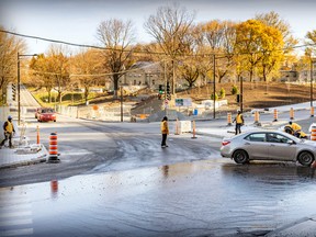 Construction crews work at the intersection of Remembrance Rd., left, and Côte-des-Neiges Rd. in Montreal Wednesday Nov. 9, 2022.