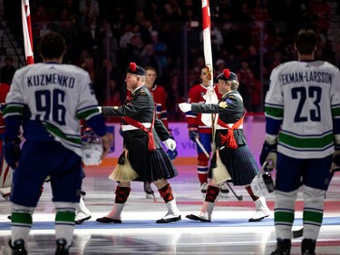 Members of the Canadian military leave the ice surface after performing the national anthem before NHL action between the Montreal Canadiens and the Vancouver Canucks in Montreal on Wednesday, Nov. 9, 2022.